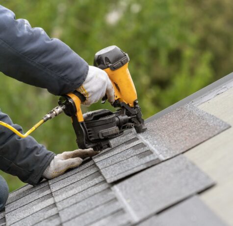 Roof replacement crew installing new shingles on a home in Northeast Ohio