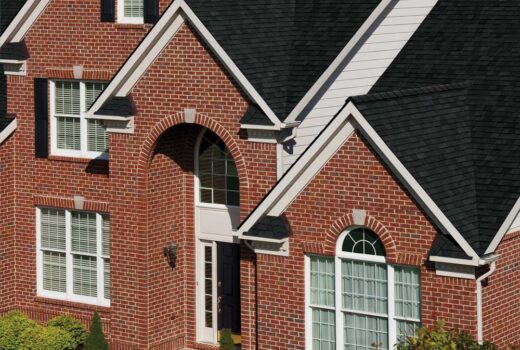 Roofer performing a roof inspection on a residential home.