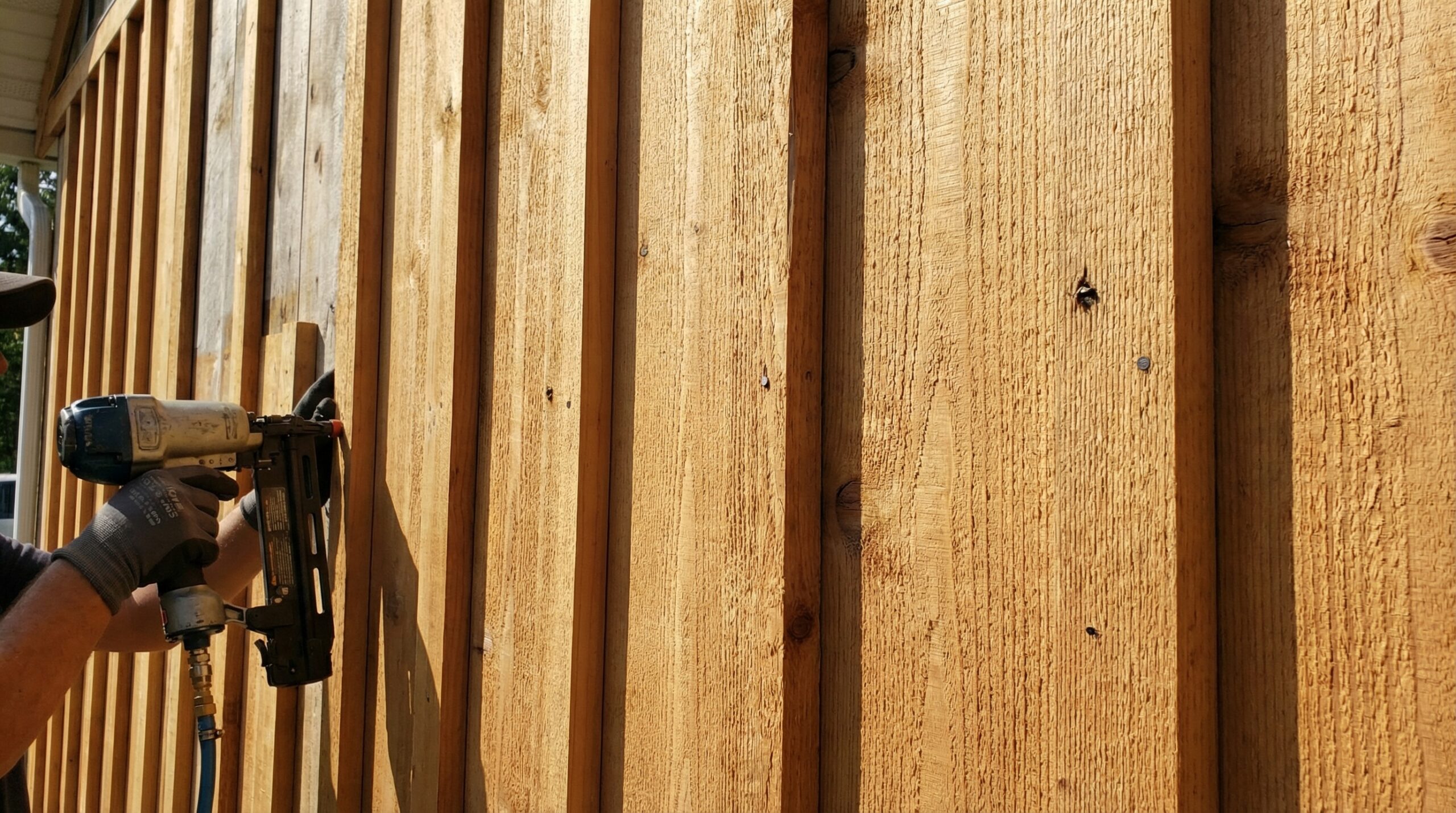 Board and batten siding installation showing vertical lines