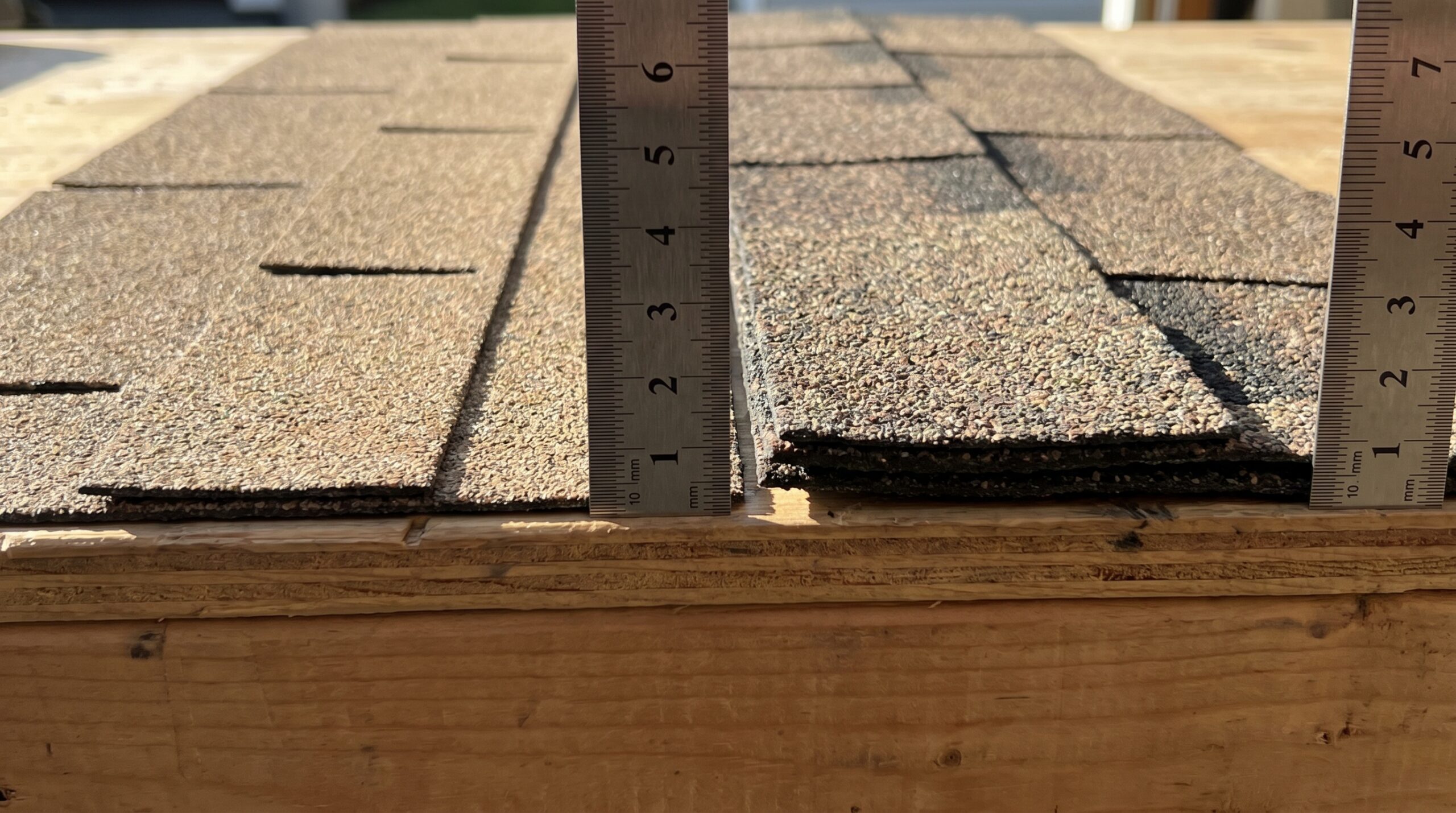 Close-up comparison showing 3-tab shingle thickness versus architectural shingle