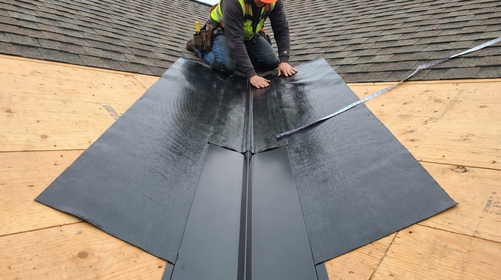 Ice and water shield installation in roof valley showing proper coverage extending 18 inches on each side