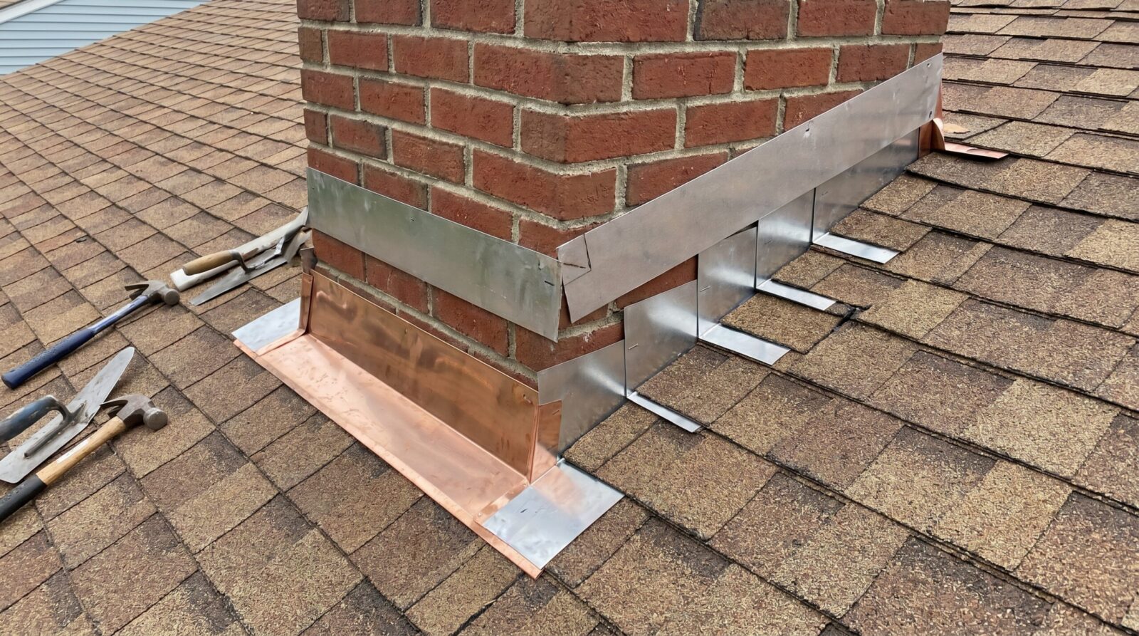 Step flashing and counter flashing installation on brick chimney
