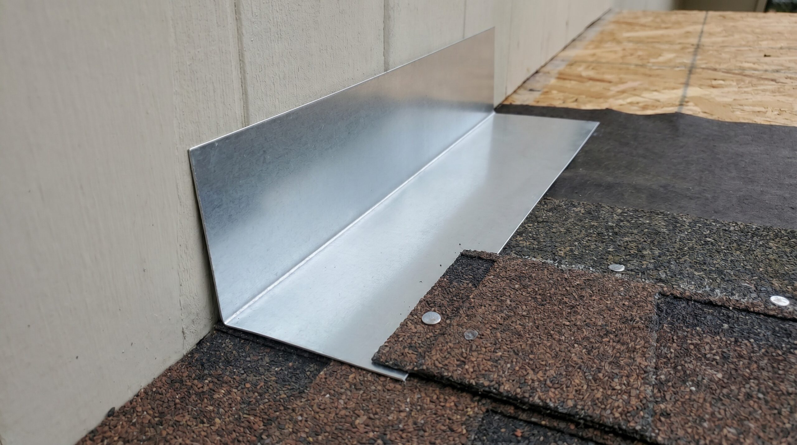 Step-by-step installation photos showing proper overlap sequence of step flashing with shingles